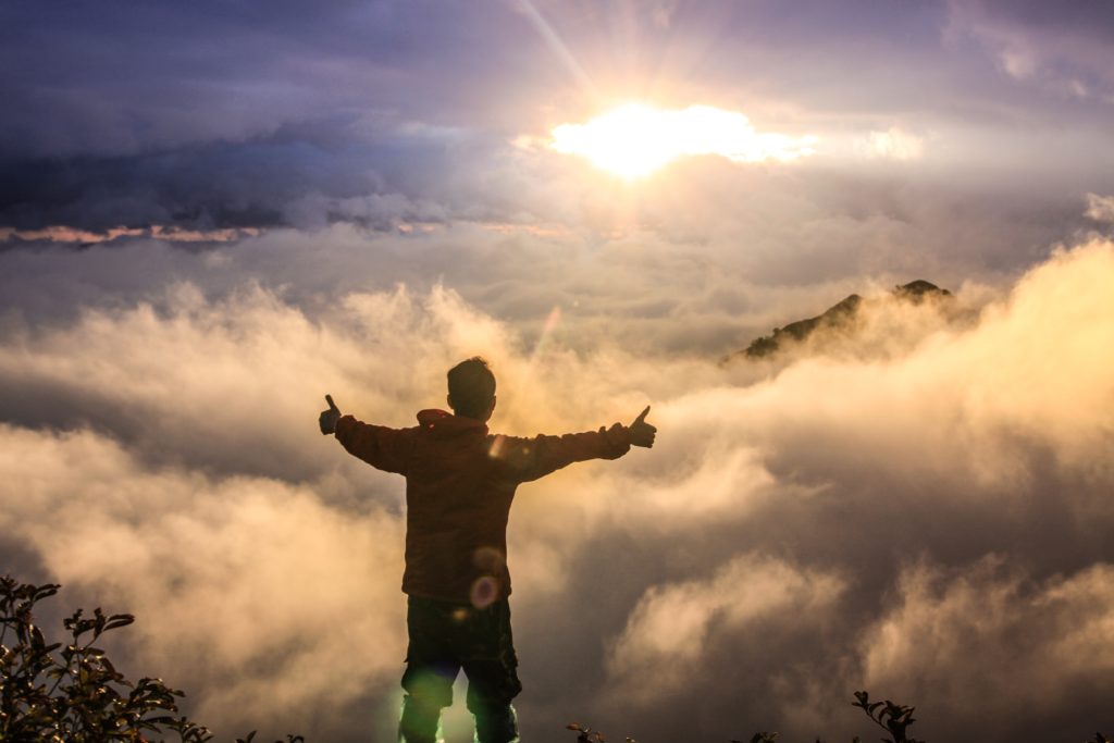 Successful boy on mountaintop