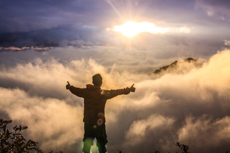 Successful boy on mountaintop